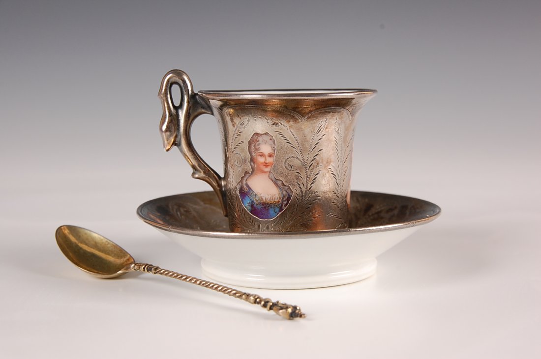 SEVRES SILVER CLAD PORCELAIN DEMITASSE WITH PORTRA: A demitasse size set with hand highlighted transfer portraits and hand engraved silver clad covering. Saucer measures 3.75 inches, cup 2 x 2.25 inches, spoon 4.25 inches. Marked S.57 in oval.