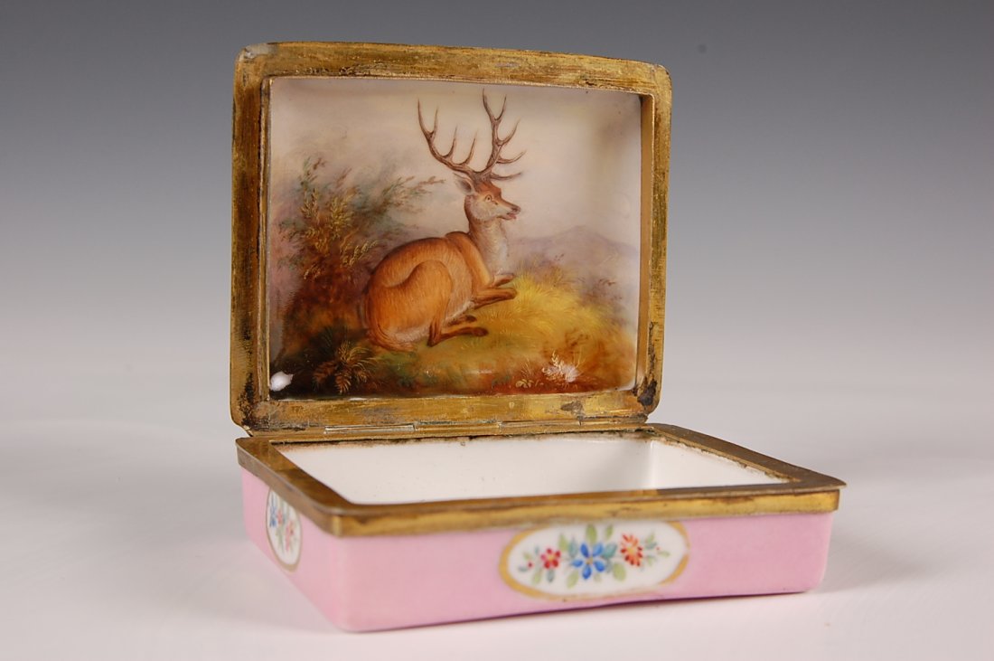19TH C. FRENCH PORCELAIN AND ENAMEL HINGED BOX: A very finely executed painted porcelain insert in the cover hinged on a pink base decorated with painted florals. Measures 3.25 x 2.75 inches.