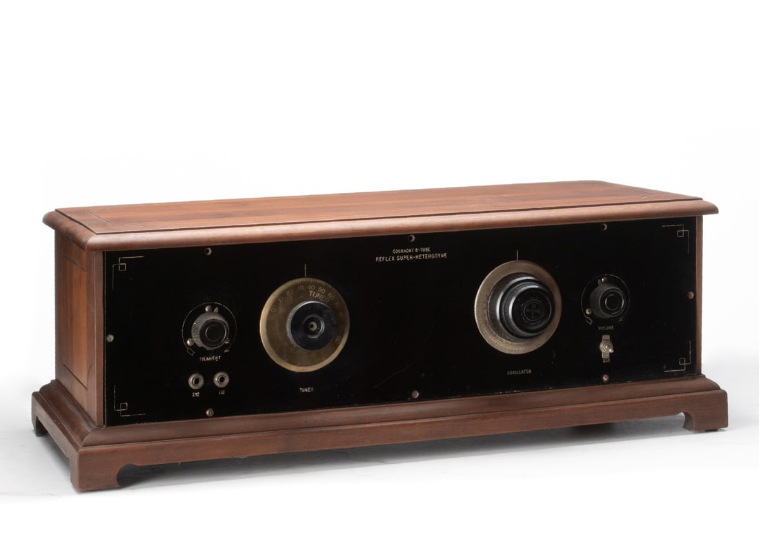A HAYNES-GRIFFIN COCKADAY RADIO CIRCA 1925.: Haynes-Griffin Radio Service 'Cockaday 8-Tube Reflex Super Heterodyne' radio in walnut case branded ' This cabinet made by International Equip Co. 14th and Michigan, K.C.MO, circa 1925. The operating 
