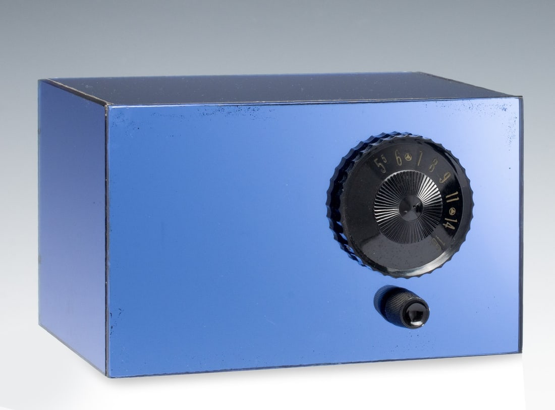 A ONE-OFF BENCH MADE BLUE MIRROR RADIO: The case is constructed from pieces of blue mirror plate joined with silicone and fitted with a four tube AM chassis. The operating condition is not known. Measures 5.75 x 9 inches. Without proof of e