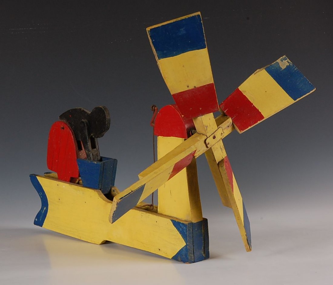 FOLK ART WHIRLIGIG WITH BLACK LAUNDRESS: Measures 14 x 18 inches.
