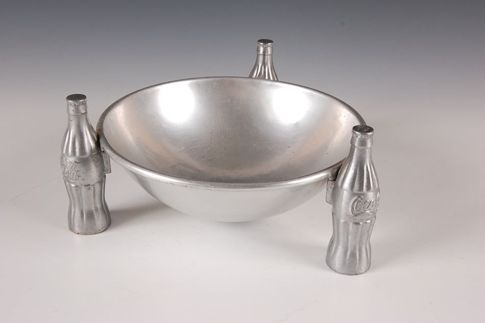1930S COCA-COLA PRETZEL BOWL STANDING ON FIGURAL BOTTLE: Measures 4.25 x 9.5 inches.