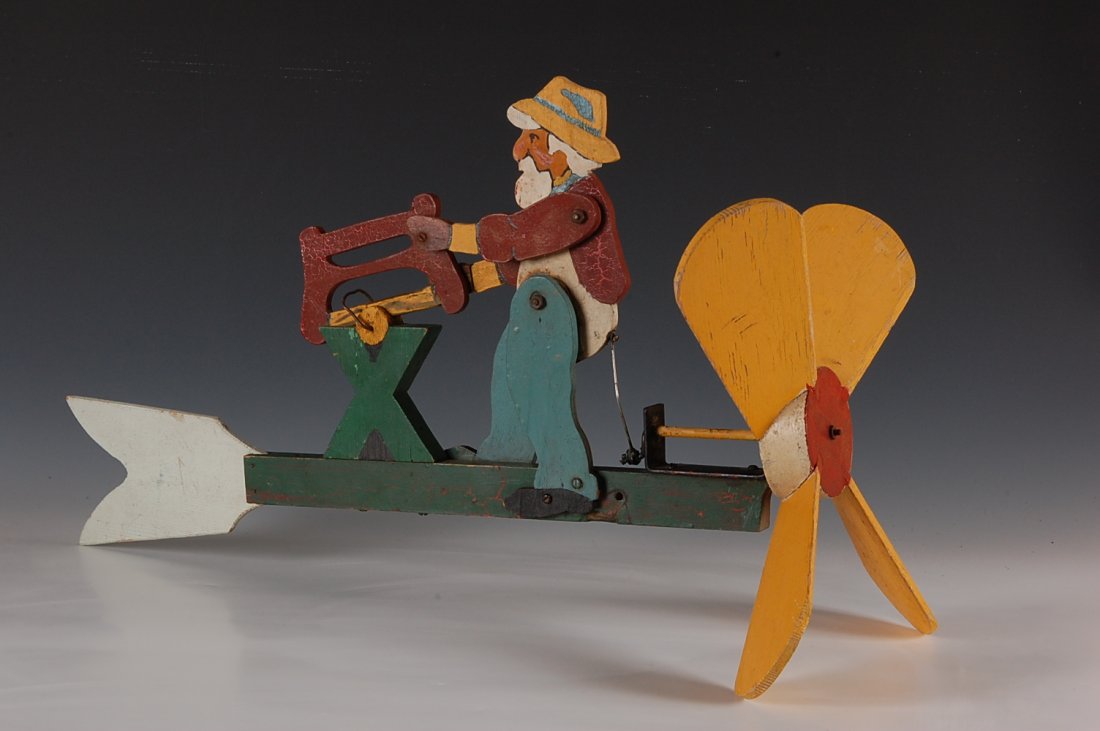 FOLK ART WHIRLIGIG WITH WOODCUTTER: Measures 10.5 x 24 inches.