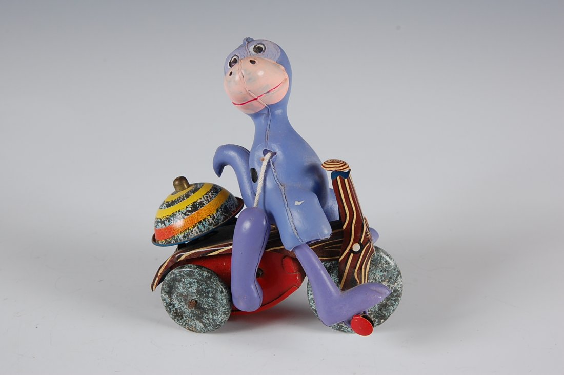 FLINTSTONES DINO ON TRIKE WIND-UP TOY BY MARX: Measures 4.5 inches.
