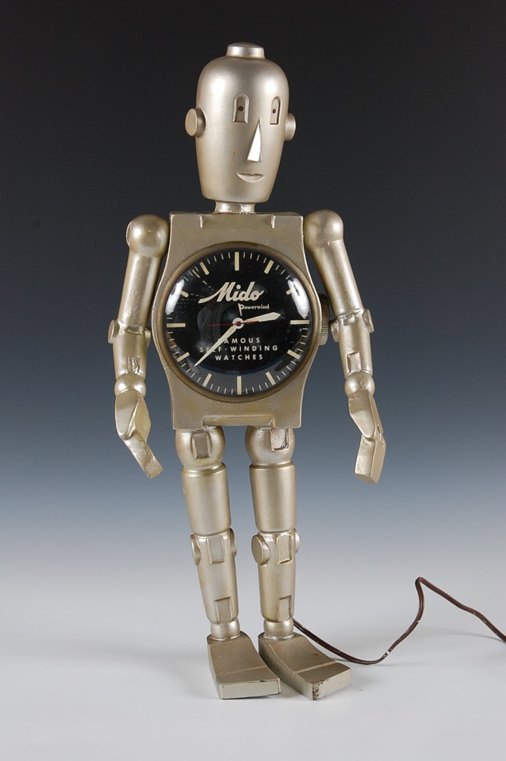 MIDO WATCHES ADVERTISING DISPLAY ROBOT WITH CLOCK: An advertising display for Mido Powerwind Self-Winding Watches. Manufactured by Copeland Displays, New York circa 1960. Measures 22.5 inches.