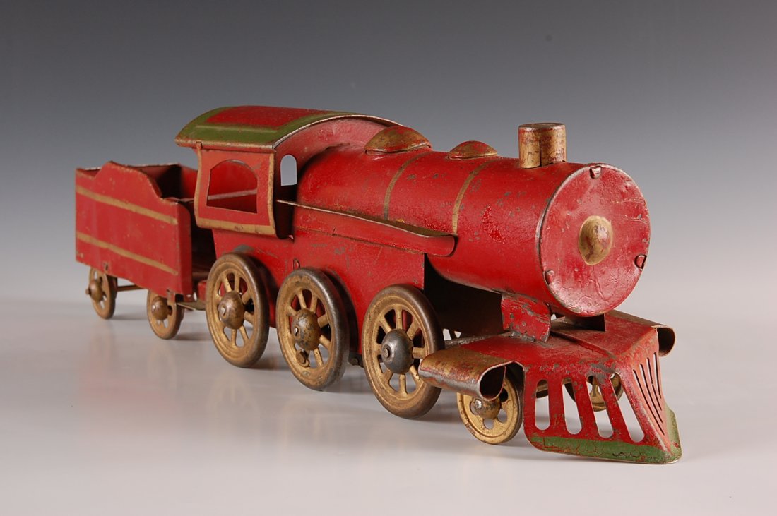 RED PRESSED STEEL FLOOR TRAIN ENGINE AND TENDER: Measures 5.25 x 3.75 x 19 inches.