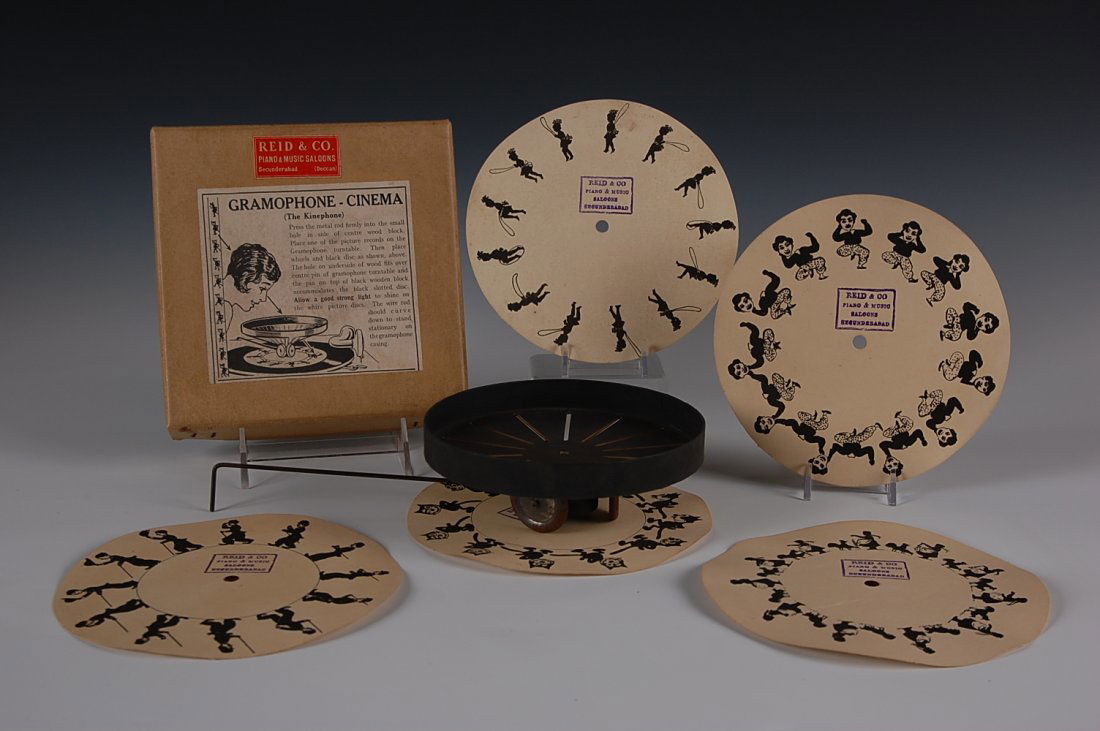 KINEPHONE GRAMOPHONE CINEMA WITH FELIX THE CAT: A novelty device that fits over the spindle of a gramophone record player and provides a visual cinema while the record spins. Included are cartoon images of Felix the cat, Charlie Chaplin and others
