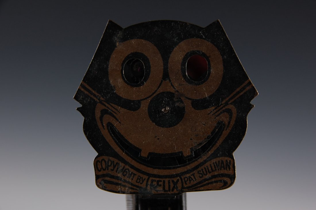 FELIX THE CAT TIN TOY SPARKLER, GERMANY: Painted tin face, mechanism is marked Germany, overall measurements of 5 x 2.5 inches.
