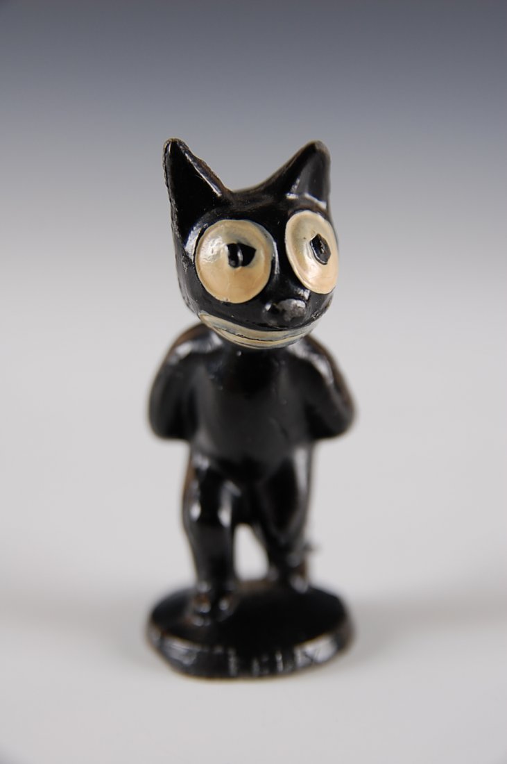 FELIX THE CAT WALKING, LEAD CAST FIGURE: All original with black enamel, embossed Felix on front of the base, and Pat Sullivan copyright info under the base, measures 2 1/4 inches