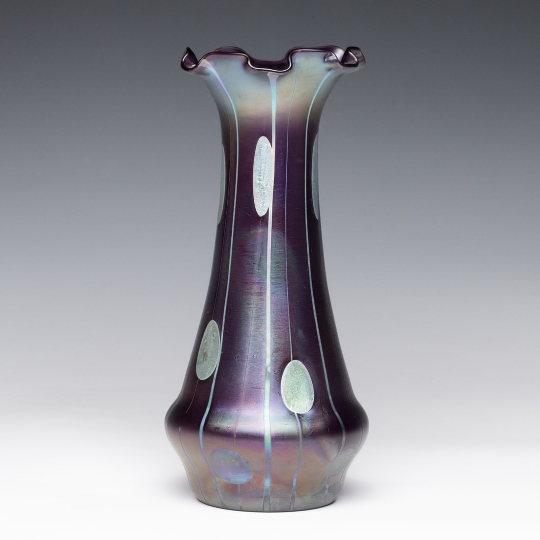 A LOETZ/MOSER STREIFEN UND FLECKEN ART GLASS VASE: Koloman Moser / Johann Loetz Streifen und Flecken Circa 1900 The amethyst base glass vase with tooled rim and polished pontil is decorated in the Streifen und Flecken (Stripes and Oil Spots) technique