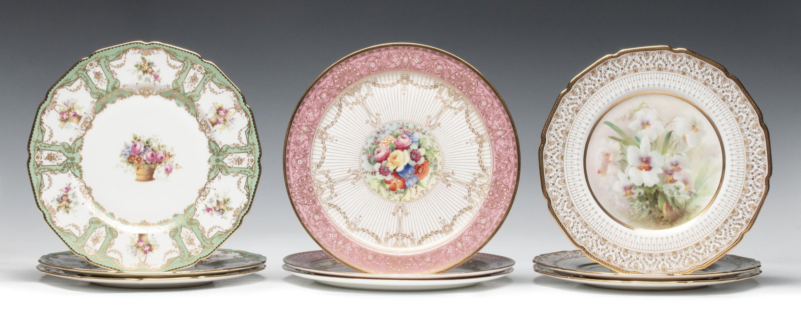 SERVICE PLATES BY ROYAL DOULTON AND ROYAL WORCESTER: 1. Three hand-painted service plates with orchids signed 'N.W. Keates for Royal Doulton.' 2. Three hand painted service plates signed E. Percy for Royal Doulton. 3. Three hand painted plates by Royal 
