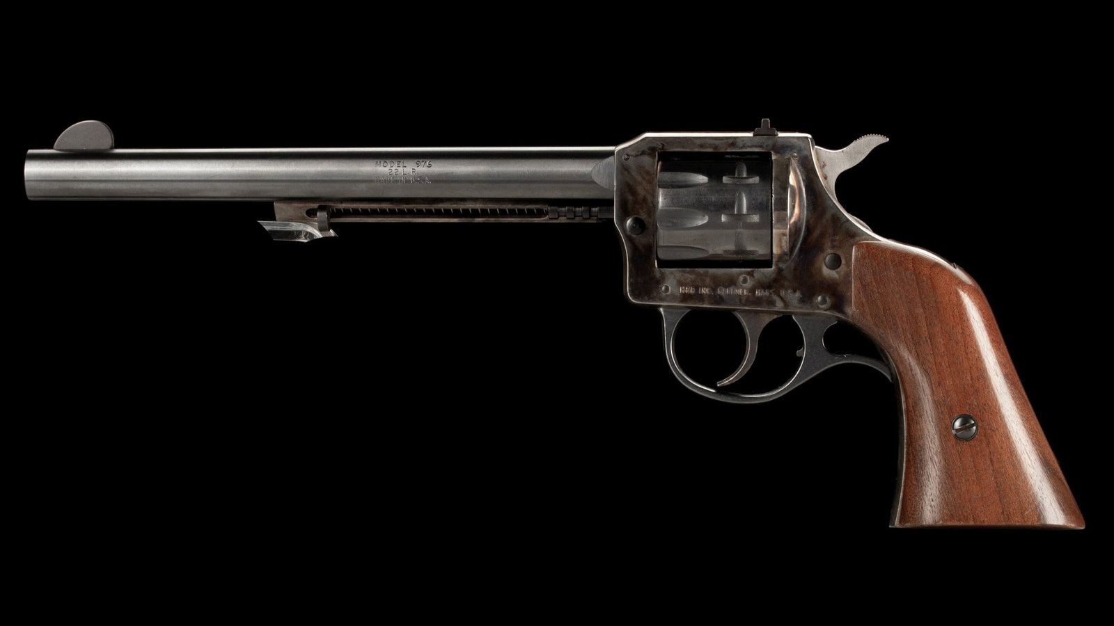H&R MODEL 976 .22CAL 9-SHOT REVOLVER: H & R Inc 22 976 (serial #:AS76852) Produced 1977-1980. 9-shot double action with blue barrel and cylinder, antique color case frame and ejector tube, one piece oversize western shaped walnut grips. B