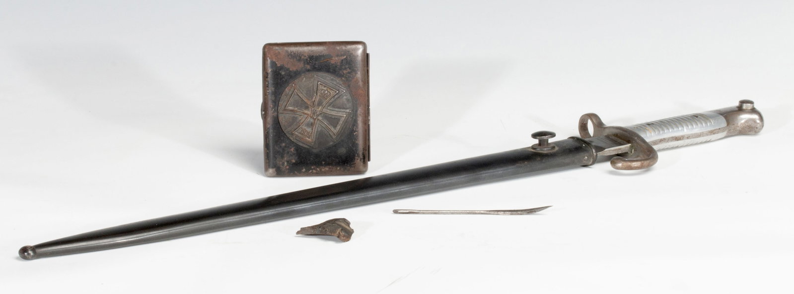 AN 1891 ARGENTINO BAYONET | IRON CROSS CIGARETTE CASE: The bayonet with its original scabbard is marked Weyersberg Kirschbaum &Co Solingen on the ricasso. It is accompanied by an Iron Cross cigarette case. $75 - $100. Sword measures 22.5 inches long and t