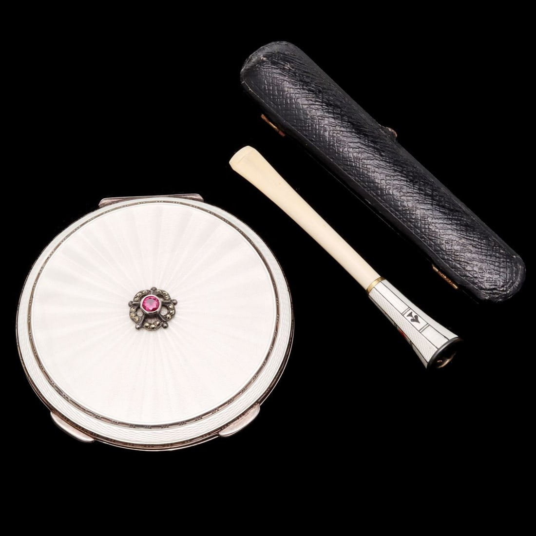 GARRARD AND OTHER STERLING & GUILLOCHE ENAMEL ARTICLES: 1. A cased enamel and natural material cigarette holder, the enameled design incorporating the four suits of playing cards. Stamped sterling hallmarks on the mouthpiece. 2. A fine sterling silver comp
