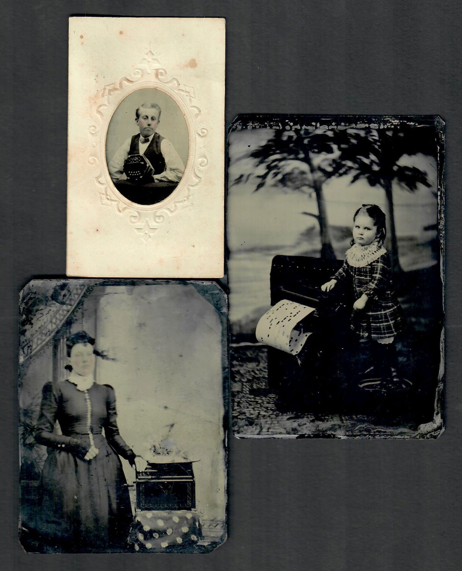 THREE TINTYPE PHOTOGRAPHS PICTURING CRANK ORGANS: Quarter plate image of a lady with crank organ, quarter plate image of a girl with crank organ, young boy with concertina. The largest measures approx. 5 x 3.25 inches. Without proof of exemption, be