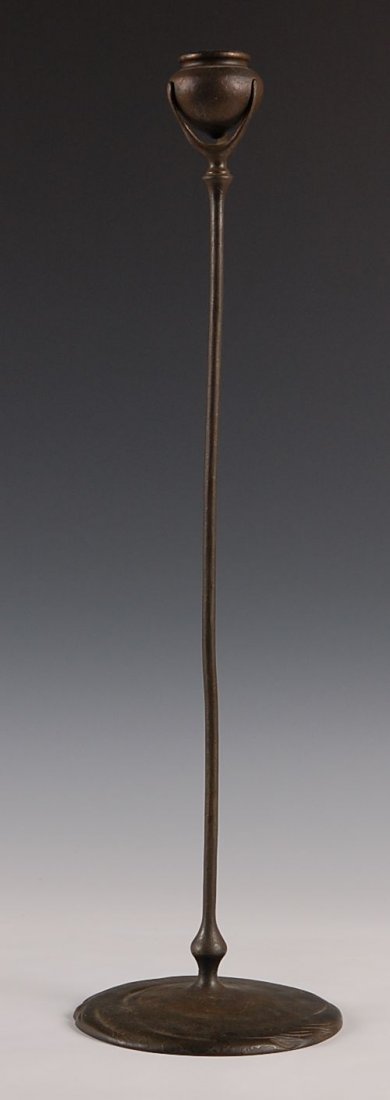 TIFFANY STUDIOS BRONZE TENDRIL CANDLESTICK #1213: A patinated bronze candlestick with stamped signature of Tiffany Studios New York, number 1213. Measures 20.5" x 6".