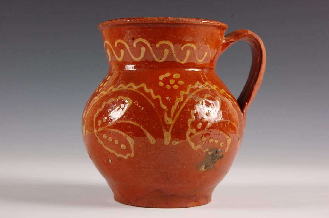 19TH CENTURY SLIP DECORATED REDWARE PITCHER: Measures 6 x 6 inches.