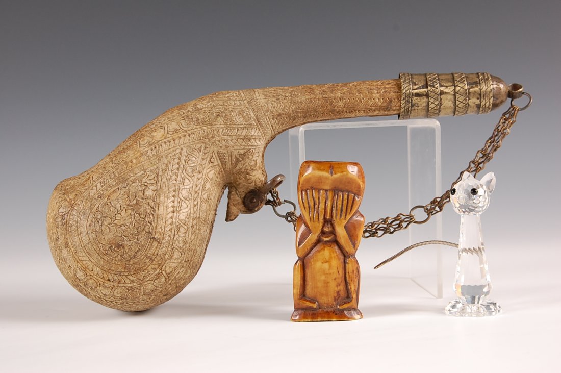 ESTATE LOT: POLYNESIAN IVORY, POWDER FLASK, SWAROVSKI C: Flask measures 11 inches. Carving 3.25 inches. Swarovski Crystal 2.75 inches. No international shipping.