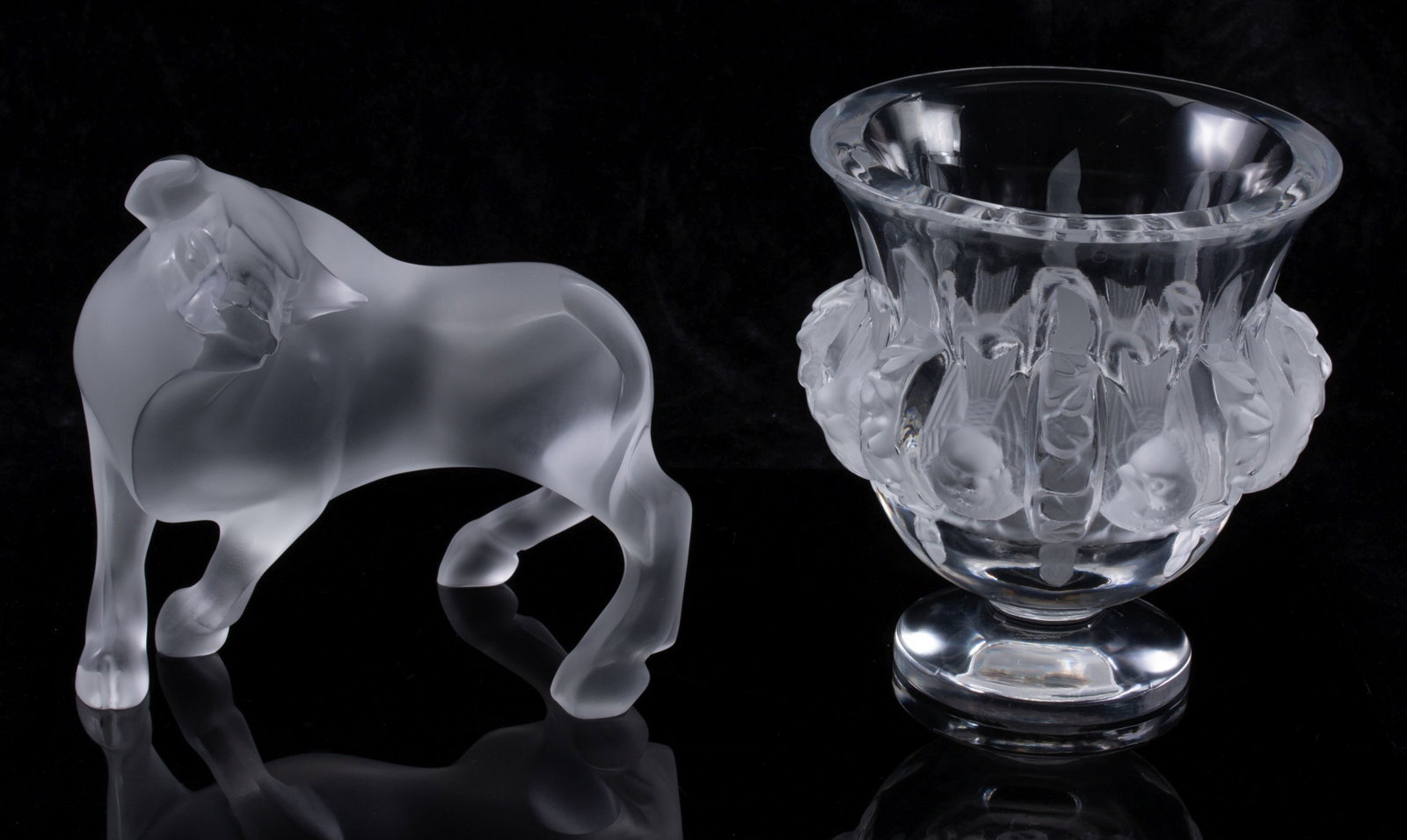 LALIQUE TAUREAU VUELTA FIGURE AND DAUMPIEERE VASE: Late 20th Century The frosted figure of a turning bull and clear crystal vase with frosted love birds are each signed lalique France. No Boxes. Measures 4.75 and 5 inches tall. Without proof of exempt