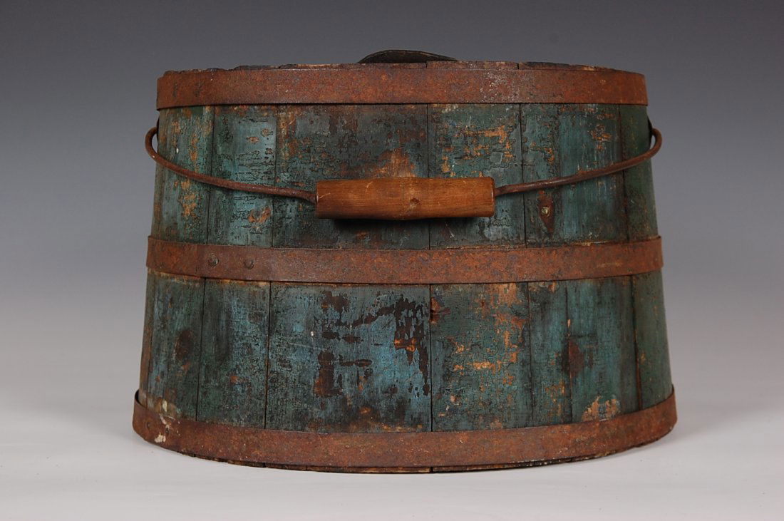 ANTIQUE SHAKER-TYPE LIQUIDS BUCKET WITH LEATHER SPOUT: Staved sides, old green paint over blue, Shaker handle characteristics. Measures 8.5 x 13 inches. Tight and sturdy