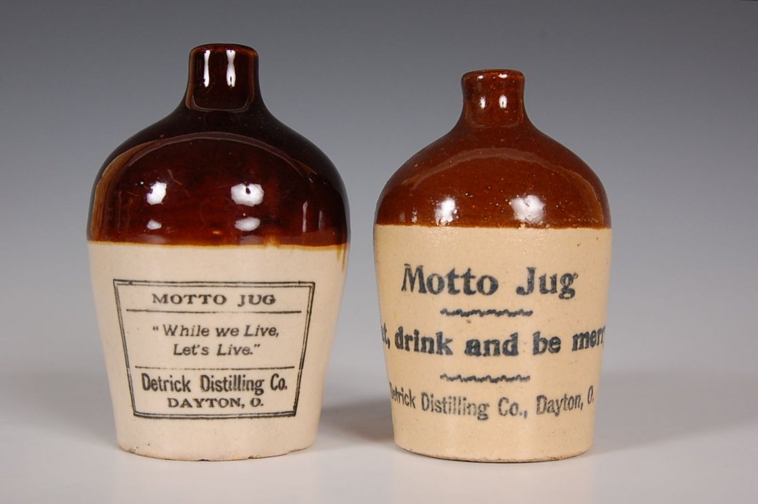 TWO STONEWARE MINI JUGS WITH MOTTO: Two miniature handled stoneware jugs with mottos from 'Detrick Distilling Co., Dayton O.' Measure 4.25 inches each.