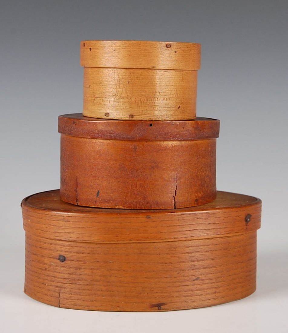 STACK OF THREE 19TH C. GRADUATED PANTRY BOXES: Iron tacks, wood pegged, one oval and two round, various woods. Measures from 7 to 3.25 inches.