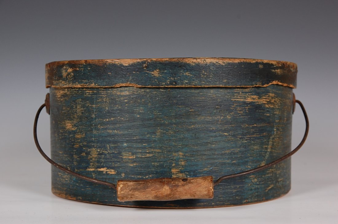 19TH C. BAIL HANDLE PANTRY BOX WITH OLD BLUE PAINT: Blue finish, wire bail with wood handle, wood pegged. New England. Measures 5.75 x 11 inches.