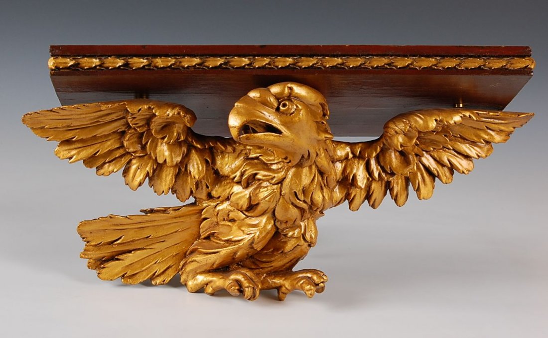 CLOCK SHELF WITH 19TH C. CARVED WOOD EAGLE: Carved wood eagle with later gilding, good detail and in the Federal style with a rectangular wooden shelf. Measures 8 x 18 x 7 inches.