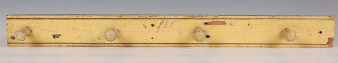 WOOD PEG RACK: Four turned pegs, pine. New England. Measures 3 x 30.5 inches.