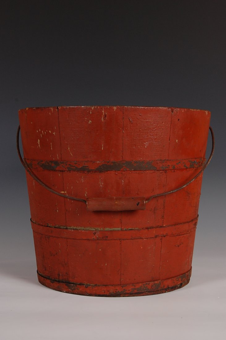 19TH C. PINE STAVED BUCKET IN OLD PAINT: Pine staved canted sides, good metal banding with diamond attachments of the handle. New York origin. Measures 11 x 13 inches.