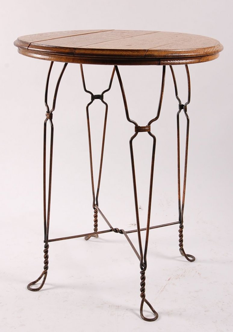 CIRCA 1910 TWISTED IRON LEG ICE CREAM TABLE W/ OAK TOP: Measures 30.5 x 24 inches.