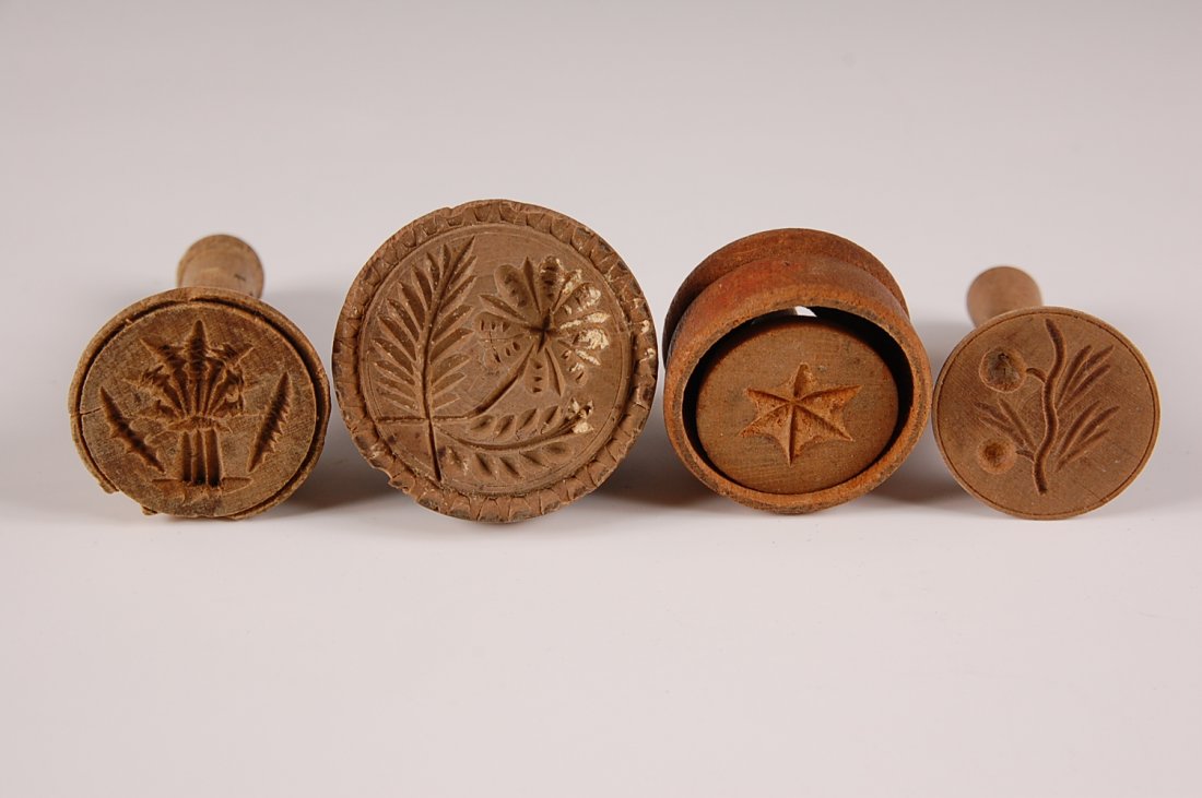 THREE SMALL BUTTER STAMPS, PLUS ONE SMALL MOLD: Stamps with floral and fruit motifs, mold with a star motif. Measure from 1.5 to 3.25 inches each.