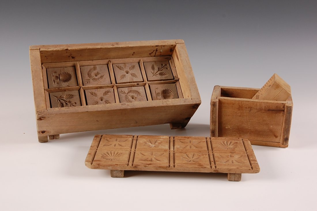 TWO BUTTER PRINTERS, PLUS A PRINTER STAMP: Large butter printer with eight removable/rearrange able stamps, stylized floral motifs, lap joints, turned wood handle, measures 4 x 11 x 5.5 inches. Small two section butter printer with the letter 