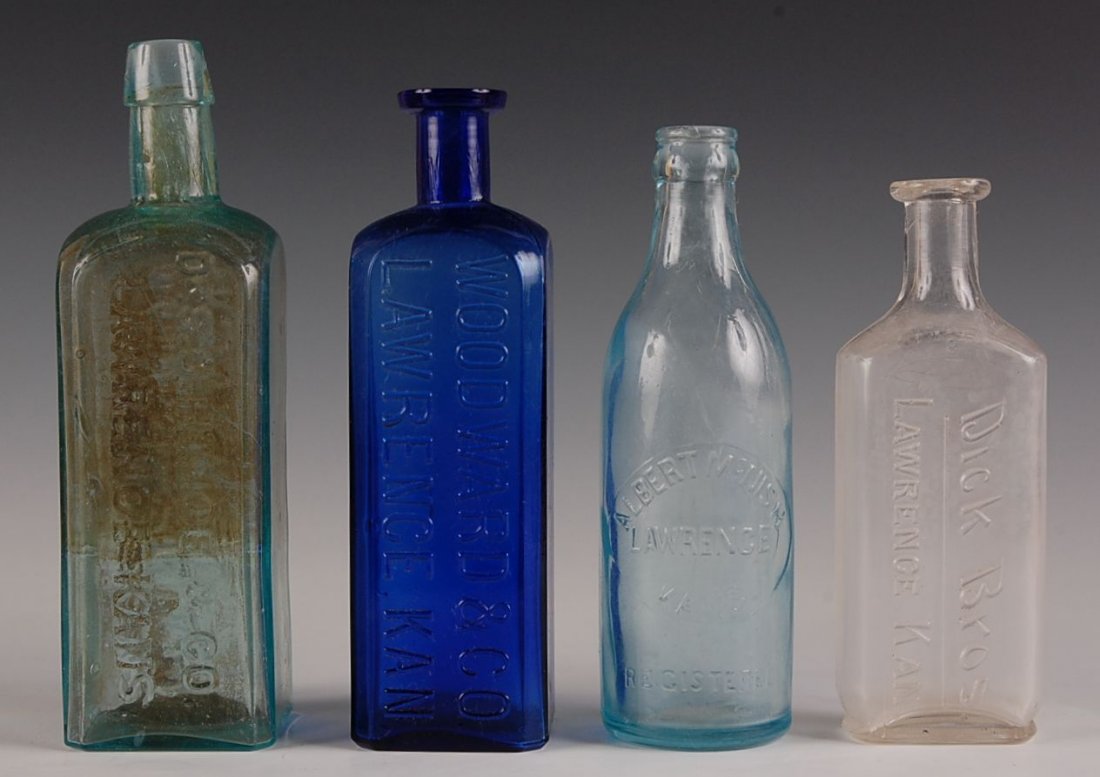 LOT OF FOUR LAWRENCE KANSAS MEDICINE AND OTHER BOTTLES: Includes Dick Bros, Lawrence Kansas clear flat square, Albert McNish aqua Soda with molded lip, cobalt Woodward and Company, Lawrence Kan and green square Drs. O. Himoe & Co. Lawrence Kansas, manufact