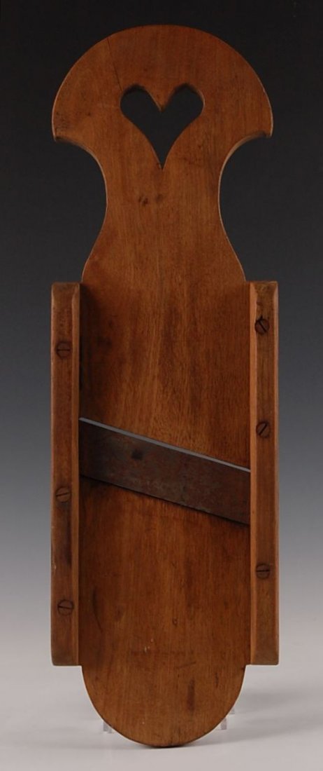 19TH C. WALNUT KRAUT CUTTER WITH HEART: Good patina, nice heart shaped cut out. Measures 20.5 x 6.25 x 1.5 inches.
