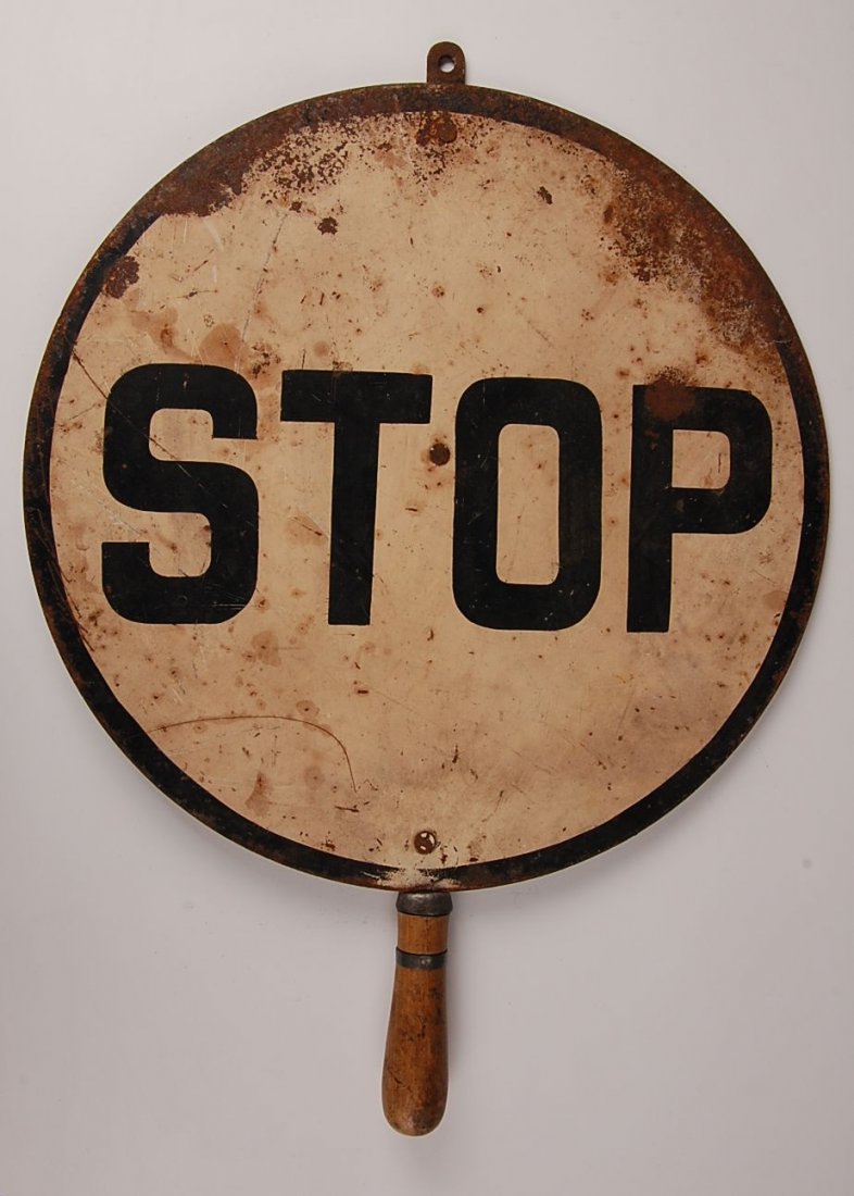 HAND HELD STOP SIGN: Double sided, wooden grip, black and white painted shows considerable oxidation. Measures 22 inches with handle.