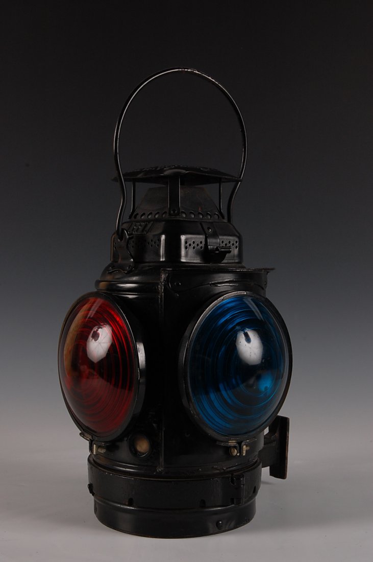 ADLAKE CHICAGO & NORTHWESTERN RR MARKER LAMP: C.& N.W. R.R. tag affixed, repainted black, measures 14 x 10 x 8 inches. Three blue, one red lens. Shows some wear and scuffing, good overall.