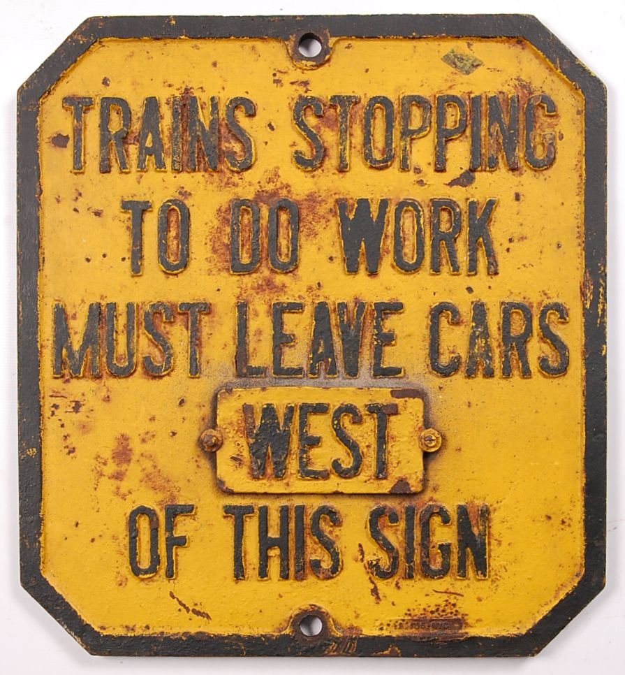 RAIL YARD MAINTENANCE SIGN: Cast iron with yellow painted background, raised black lettering 'Trains stopping to do work must leave cars west of this sign.' Measures 22 x 20.25 inches. 'West' is a screwed-on plate. Shows signifi