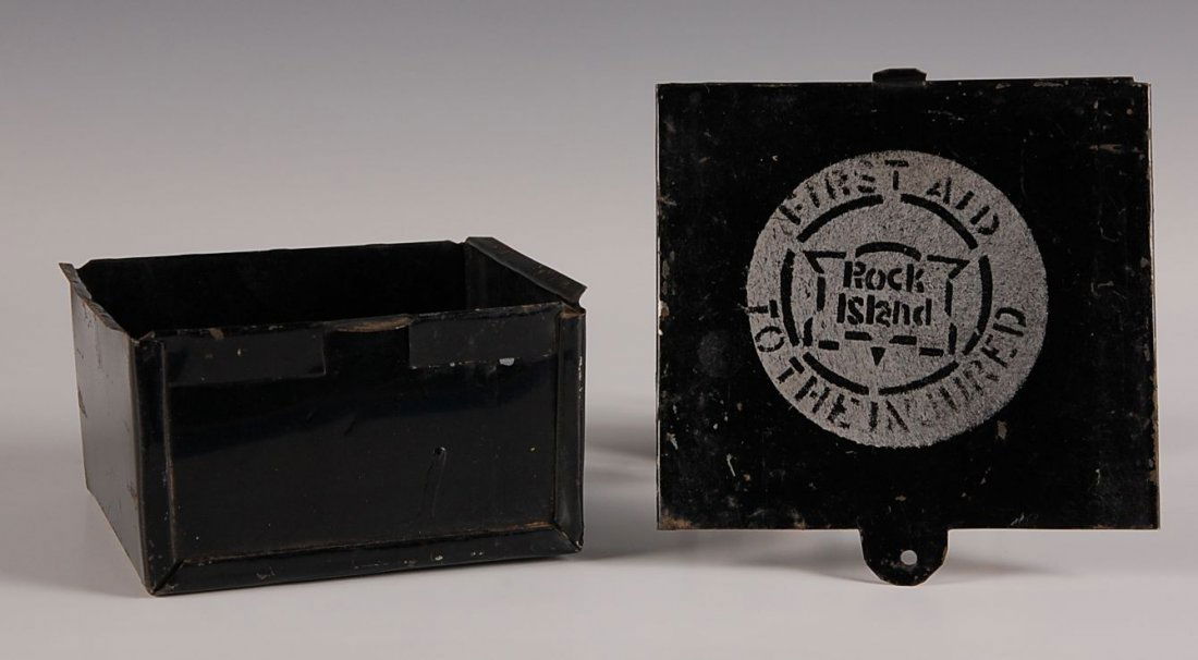 ROCK ISLAND RAILROAD FIRST AID KIT: Black painted tin with slid-off lid, Rock Island 'First Aid to the Injured'. Measures 4.75 x 5 x 2.75 inches. Some wear and toning, no contents.