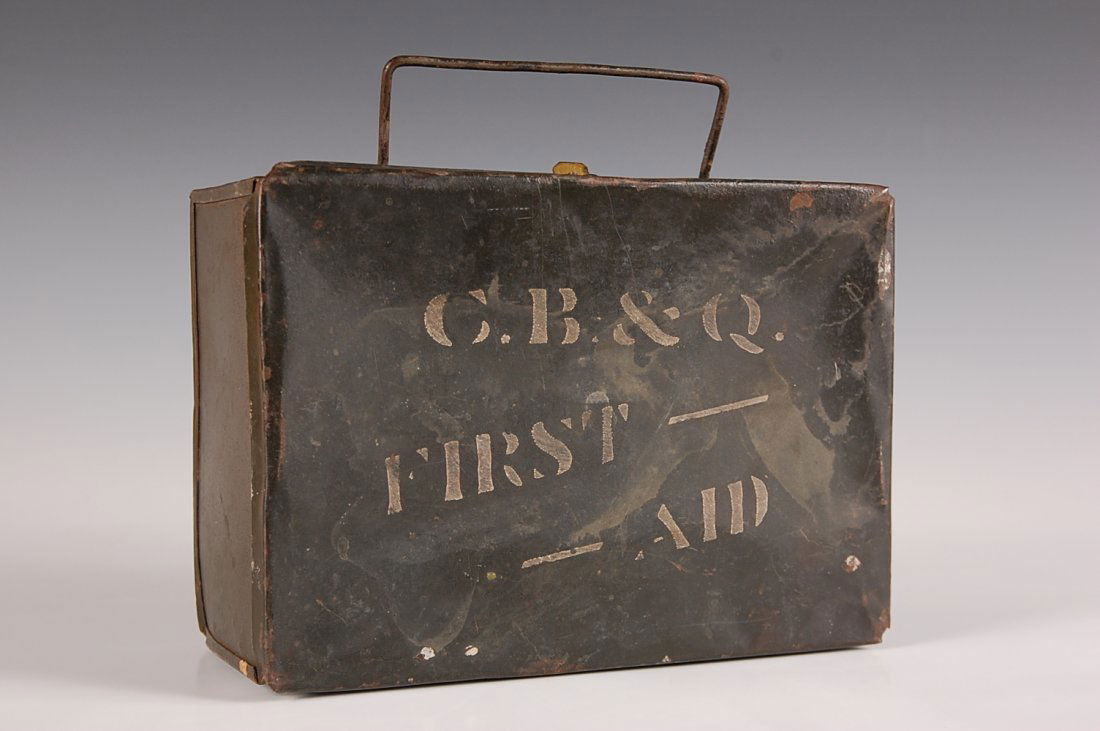 CHICAGO BURLINGTON & QUINCY RR FIRST AID KIT TIN: Dark olive painted tin with white stenciled 'C.B. & Q. First Aid' on lid. Wire handle. Measures 6.25 x 8.75 x 4 inches. Shows some wear, denting and paint loss, a bit of oxidation here and there.