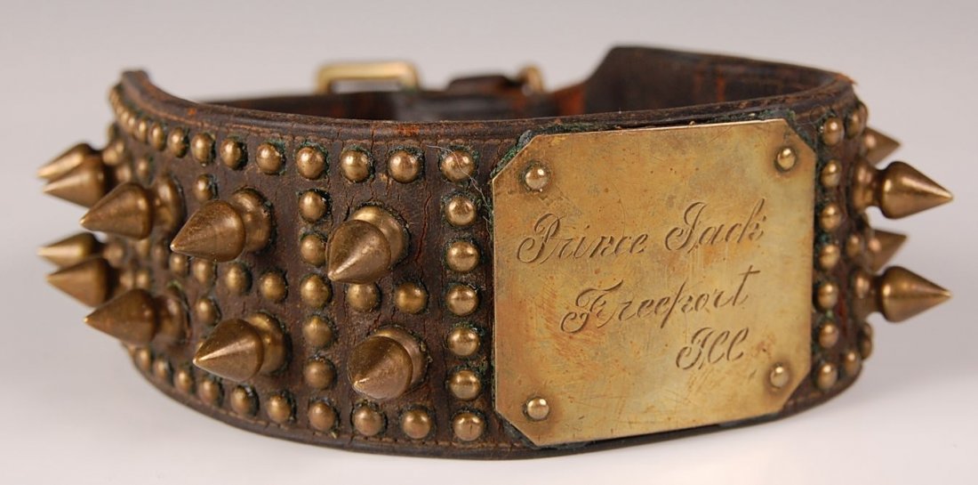 C. 1890 STUDDED LEATHER DOG COLLAR WITH LOCK AND TAG: Two-layered leather collar with domed rivets and tree spikes, engraved brass plate applied, 'Prince Jack, Freeport, Ill.' With functioning lock and key. Measures approximately 19 inches.