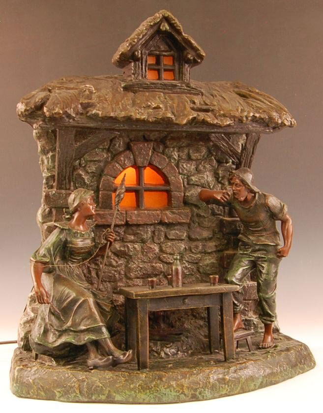 1920S FRENCH SPELTER GROUPING AFTER RAPHANEL: Signature of X. Raphanel for Xavier Raphanel on one end of the base and MADE IN FRANCE on the opposite side. Good original patinated surface and a light behind the window. Measures 19 x 16 x 8.5 inche