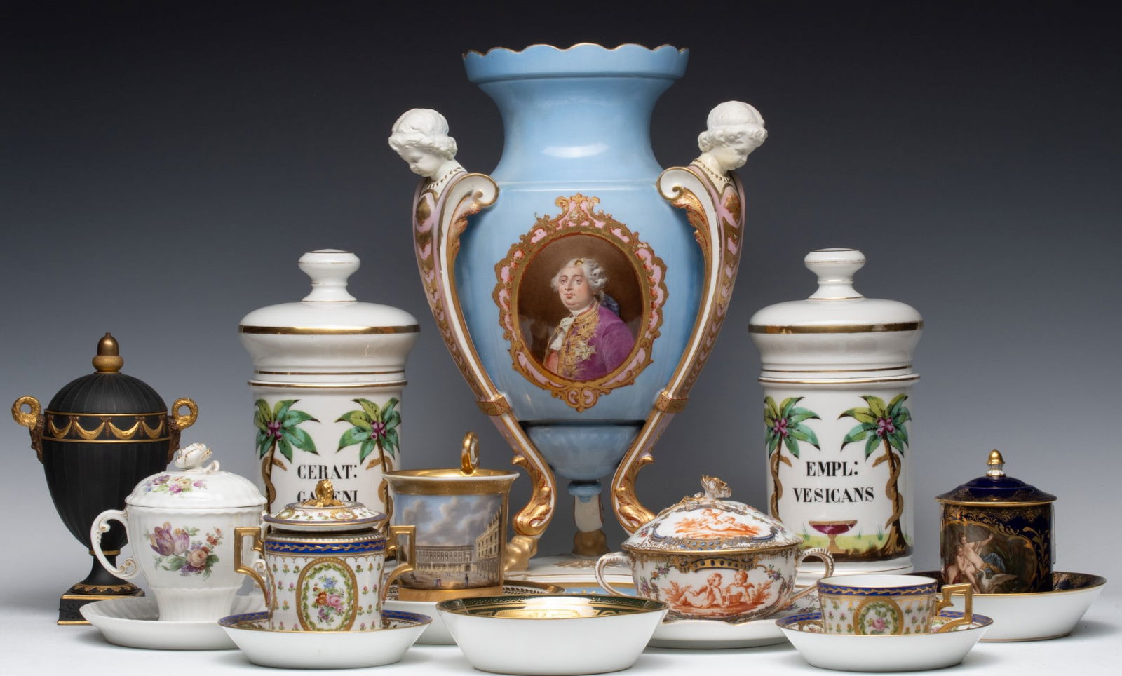 AN ESTATE COLLECTION OF ANTIQUE CONTINENTAL PORCELAIN: The collection of hand painted wares is offered as shown. Pair of apothecary jars are hand painted, unmarked, no chips, cracks or repair repairs. Tallest covered cup is marked KPM, no chips, cracks or