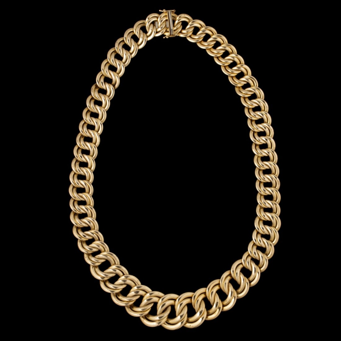 AN ITALIAN 14K GOLD CURB-LINK CHOKER NECKLACE: The wide rounded curb design necklace is stamped 14Kt ITALY on the clasp with maker's hallmark. Chain length is 17.25 inches. Weighs 44.9 grams. Without proof of exemption, be aware that internet sale