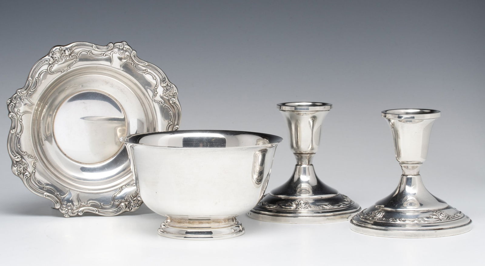 ESTATE LOT OF STERLING SILVER HOLLOW AND WEIGHTED WARES: A pair of weighted candle holders are offered with two solid sterling silver Gorham bowls, no engraving or monograms. Weighs 8.1 ozt without the two weighted candlesticks. Without proof of exemption,