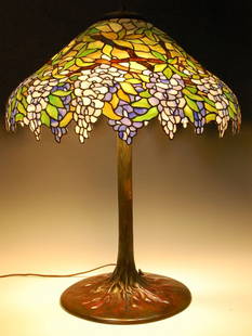 HANDEL (ATTRIBUTED) WISTERIA SHADE, TIFFANY STUDIOS BAS: An unsigned Wisteria pattern green patinated leaded glass shade attributed to Handel, the shade itself measures approximately 10 high with a diameter of approximately 24 inches. The base is a Tiffany
