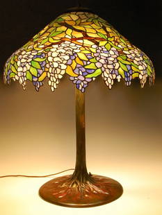 HANDEL (ATTRIBUTED) WISTERIA SHADE, TIFFANY STUDIOS BAS: An unsigned Wisteria pattern green patinated leaded glass shade attributed to Handel, the shade itself measures approximately 10 high with a diameter of approximately 24 inches. The base is a Tiffany