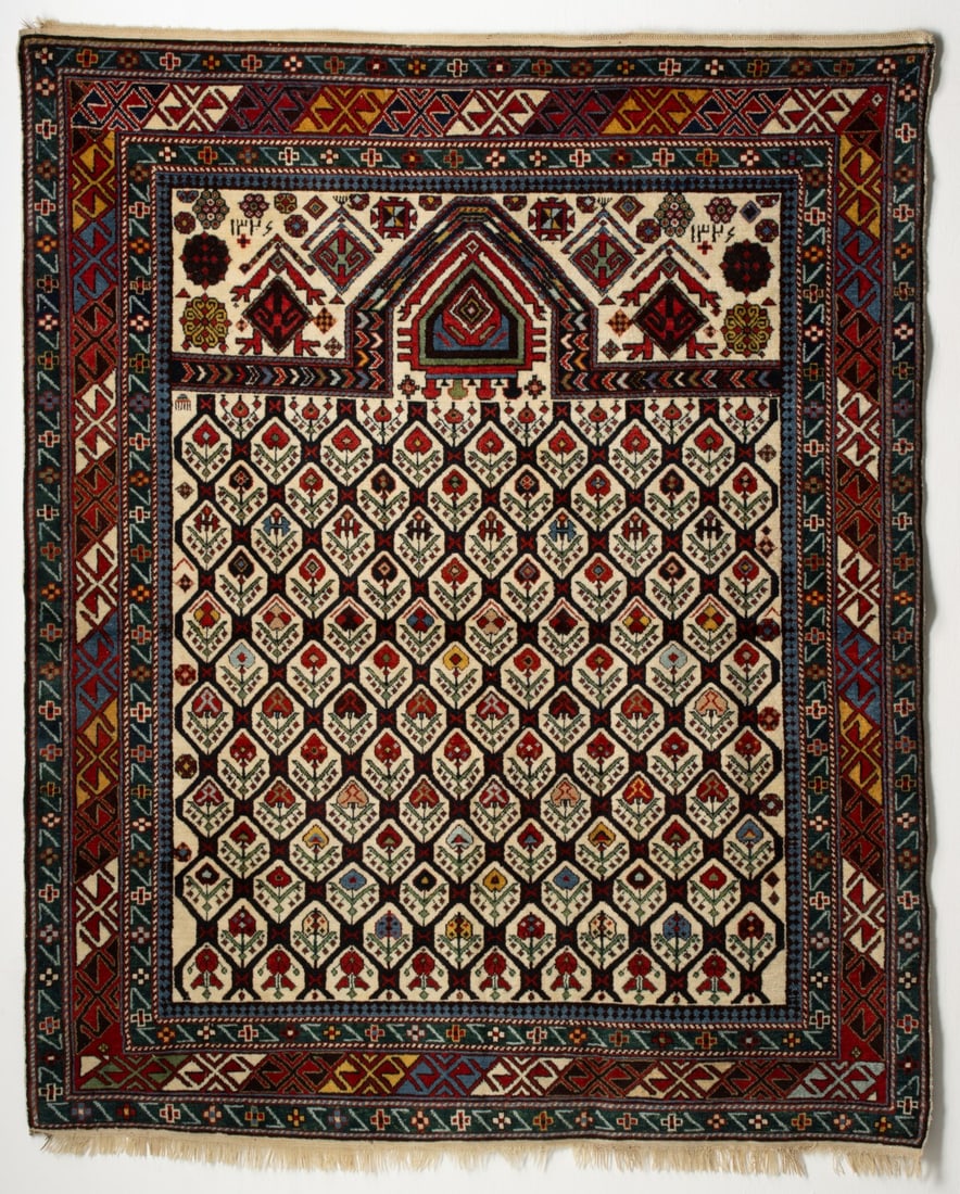 A DAGHESTAN PRAYER RUG, DATED AH 1326/AD 1908 (1 of 18)