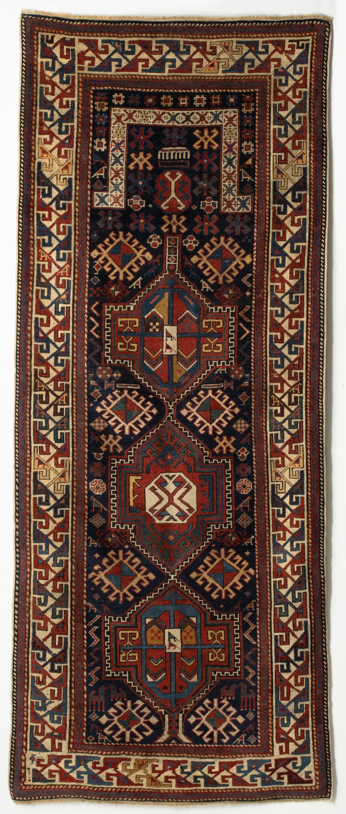 A SHIRVAN PRAYER RUG OF NARROW FORM, CIRCA 1880 (1 of 18)