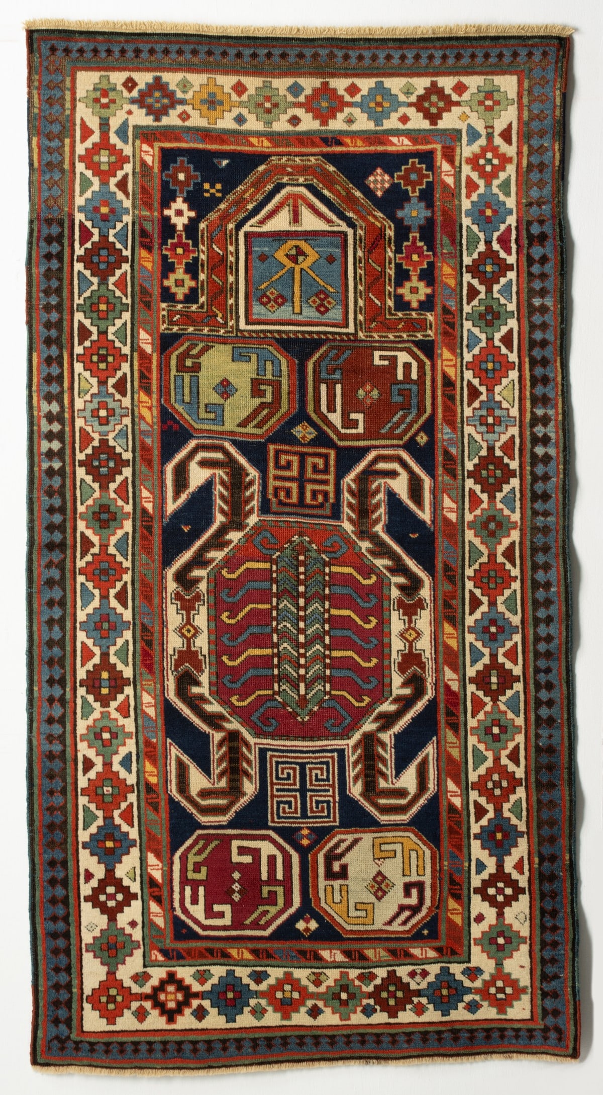 UNUSUAL LENKORAN PRAYER RUG, LATE 19TH CENTURY: The blue field with a large characteristic octagonal 'beetle' filled medallion framed with ivory brackets enclosing zoomorphic forms, between octagonal medallions below a square medallion and pointed